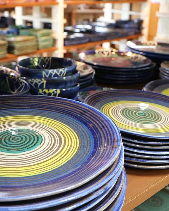 Ceramic plates on the shelf at Earthworks Pottery studio