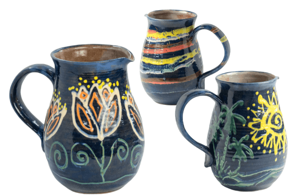 A selection of colorful pottery jugs, ranging in size and with various intricate patterns.