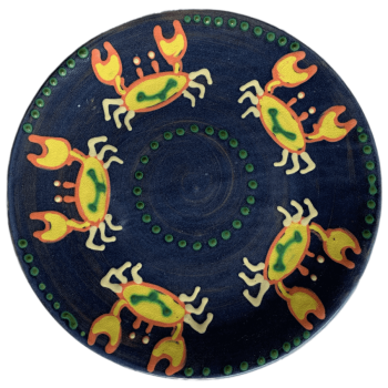 Pottery design with blue background with sand crabs dancing around the edges.