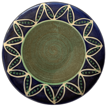 Round pottery pattern with blue with white pods and green seeds.