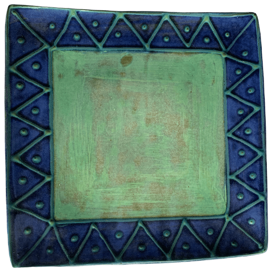 Square pottery design with green centre, turquoise sunburst on blue background.