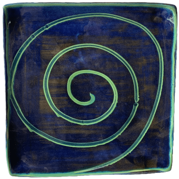 Square pottery design with blue background with green swirl.