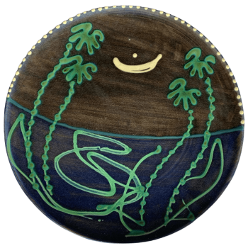 Round pottery design with deep blue background with moon and stars.