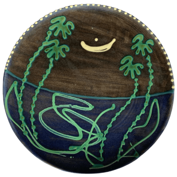 Round pottery design with deep blue background with moon and stars.