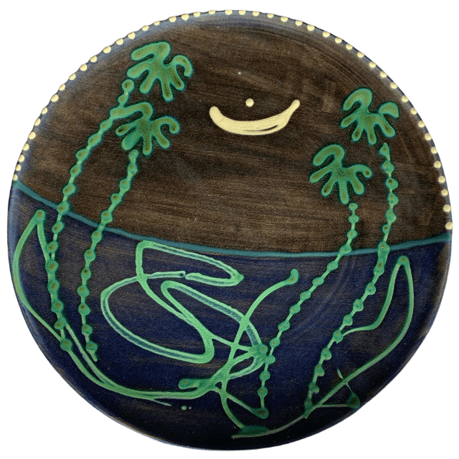 Round pottery design with deep blue background with moon and stars.