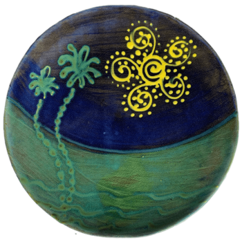 Round ceramic pottery design with evocative sun and palm tree design.