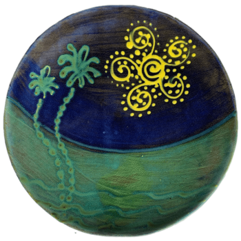 Round ceramic pottery design with evocative sun and palm tree design.