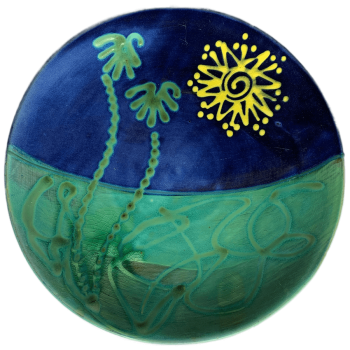 Round pottery design with sun and palm tree pattern.